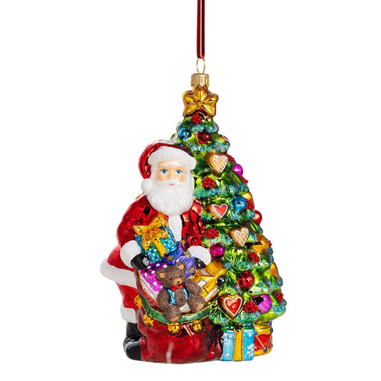 Babbo Natale della Fondazione HF che lascia regali sotto l'albero